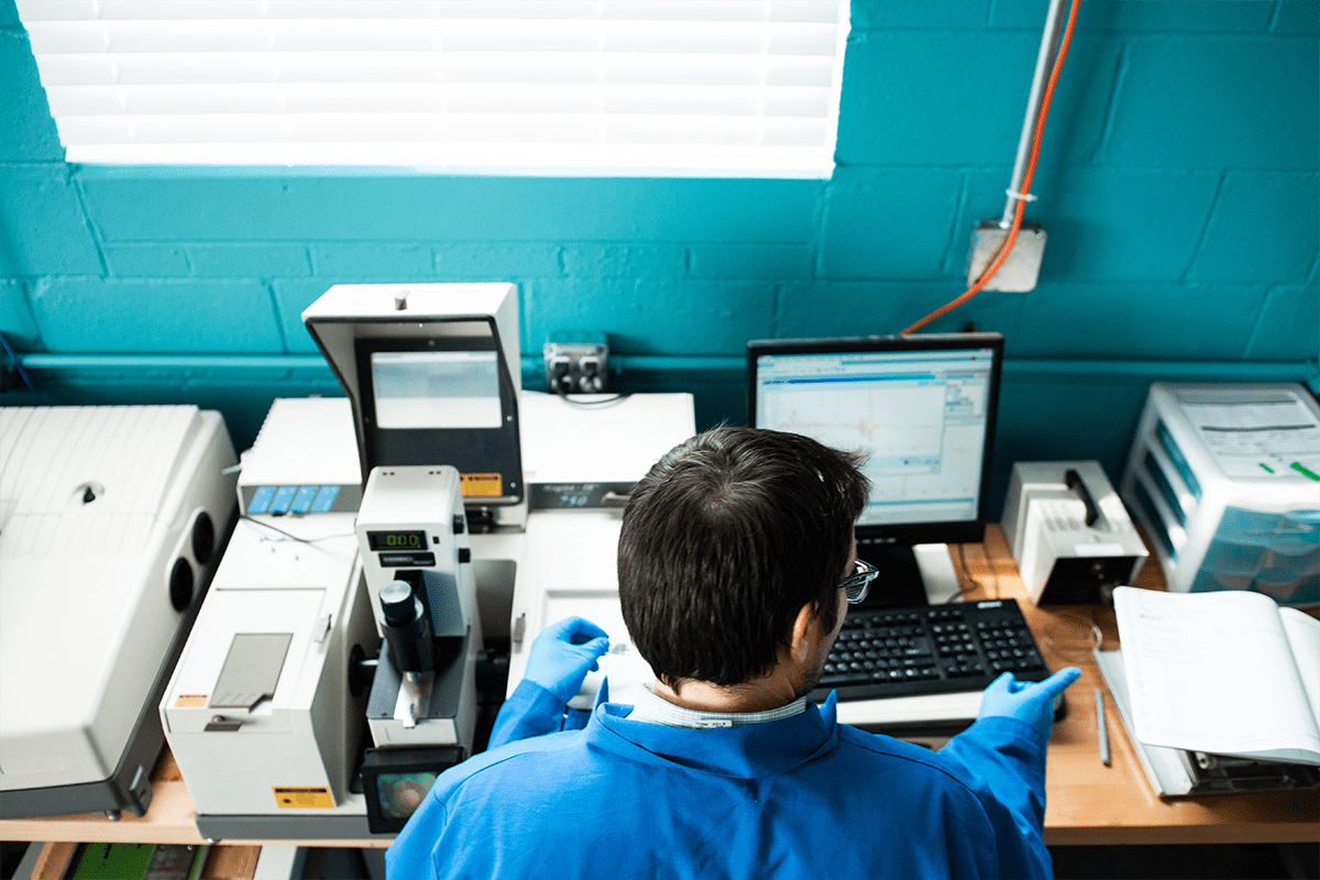 Brighton employee working on lab equipment