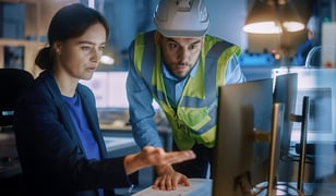 quality assurance team member showing engineer data on a computer