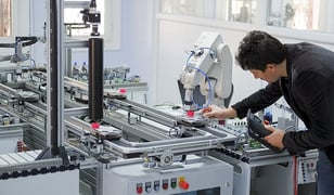 engineer-holding-tablet-controlling-collaborative-robot-on-production-line-industry-4.0